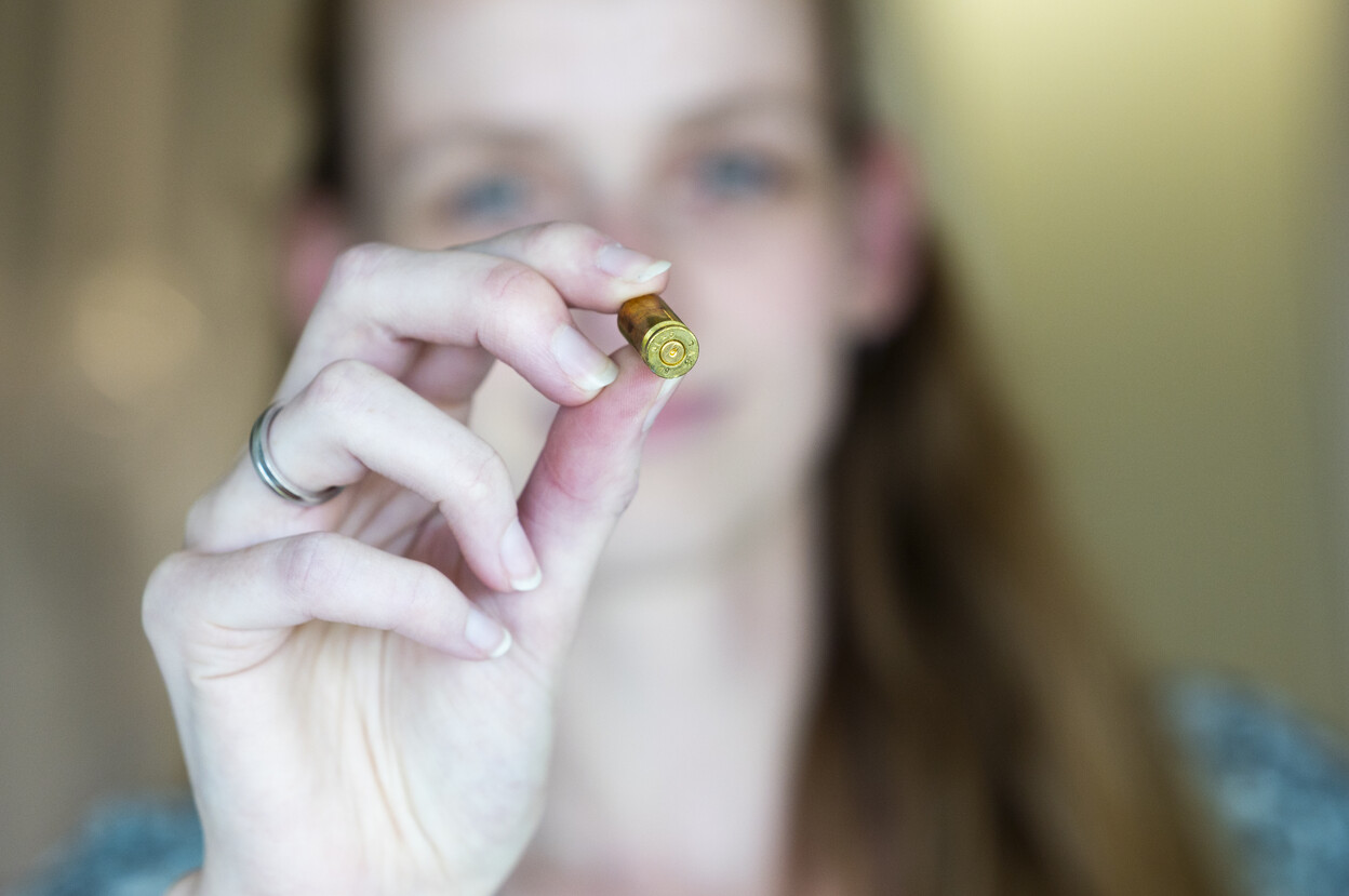 Onderzoeker laat de onderkant van een huls zien